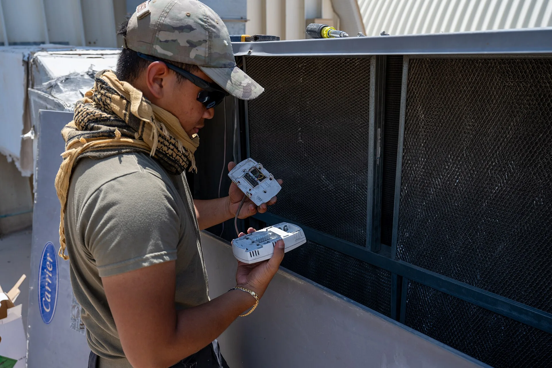 A heating, ventilation and air conditioning technician assigned to the 379th Expeditionary Civil Engineer Squadron inspects a thermostat at an undisclosed location within the U.S. Central Command area of responsibility, June 26, 2024. Prolonged temperatures above 115 degrees Fahrenheit can cause fai. How HVAC contractors can structure pricing to protect profit